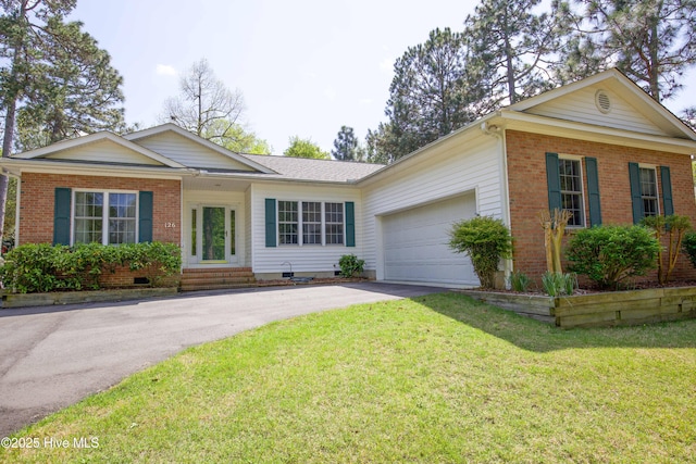 single story home featuring driveway, crawl space, a front yard, brick siding, and a garage