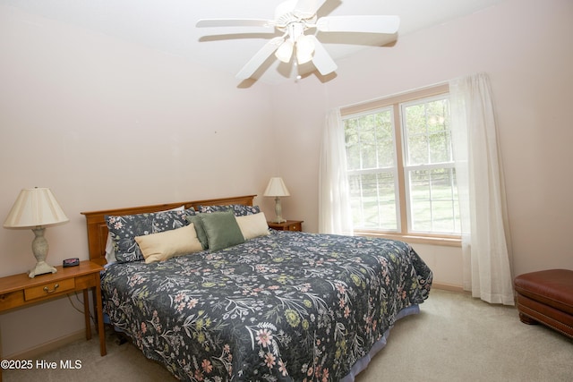 bedroom with ceiling fan, baseboards, and carpet floors