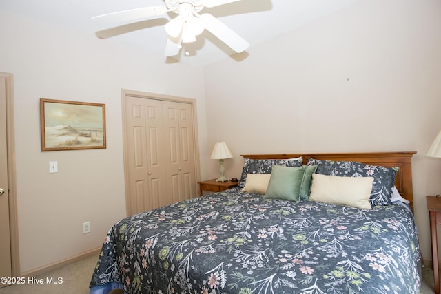 carpeted bedroom with a closet, baseboards, and ceiling fan