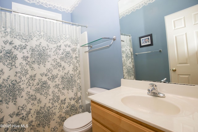 bathroom with toilet, vanity, and a shower with curtain
