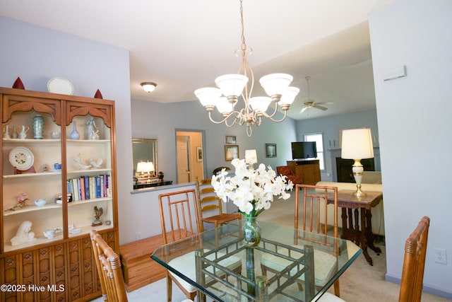 dining area featuring ceiling fan with notable chandelier