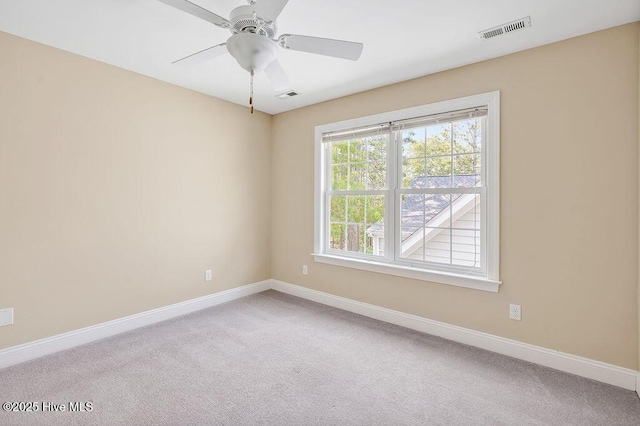 spare room with carpet flooring, baseboards, and a ceiling fan