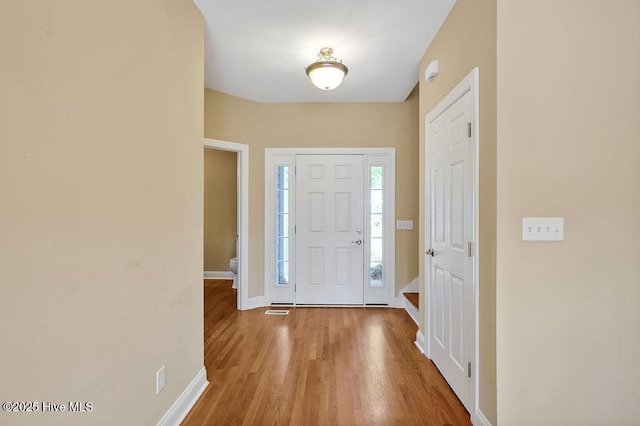 entrance foyer featuring baseboards and wood finished floors