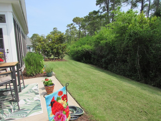 1381 Ellsworth Dr SW, Ocean Isle Beach, NC 28469 - view of grassy yard featuring a patio area