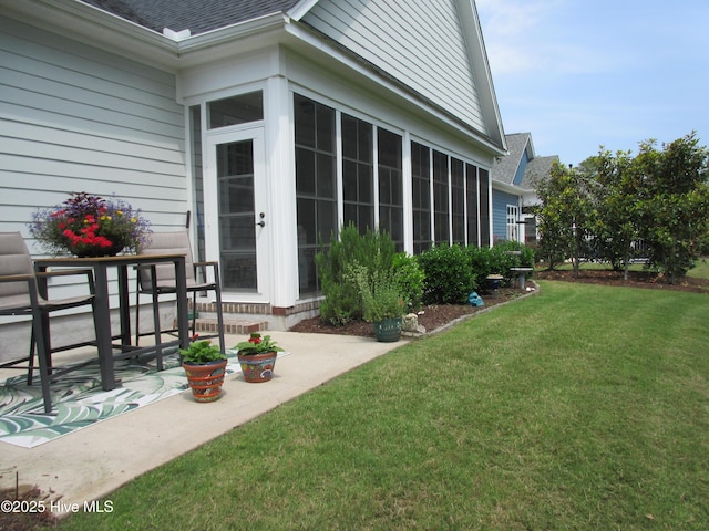 1381 Ellsworth Dr SW, Ocean Isle Beach, NC 28469 - view of grassy yard featuring a patio area and a sunroom