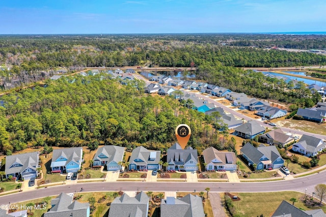 1381 Ellsworth Dr SW, Ocean Isle Beach, NC 28469 - aerial view of residential area with a heavily wooded area and a large body of water