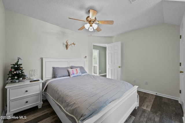 bedroom with dark wood-type flooring, a textured ceiling, baseboards, and ceiling fan