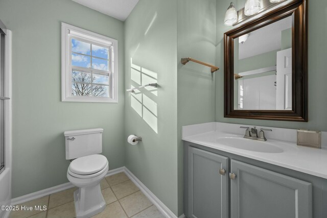 full bathroom with baseboards, toilet, tile patterned floors, and vanity