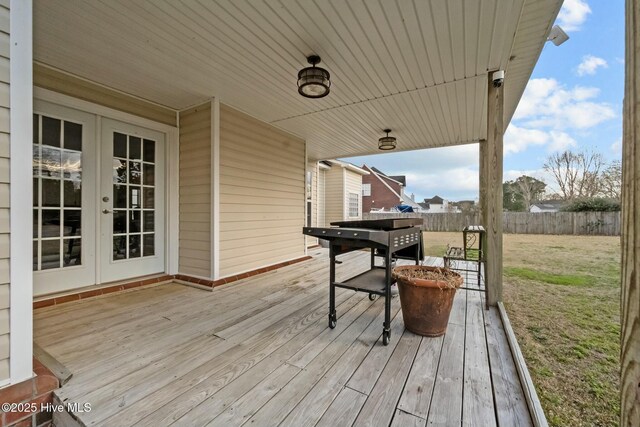 deck featuring french doors and fence