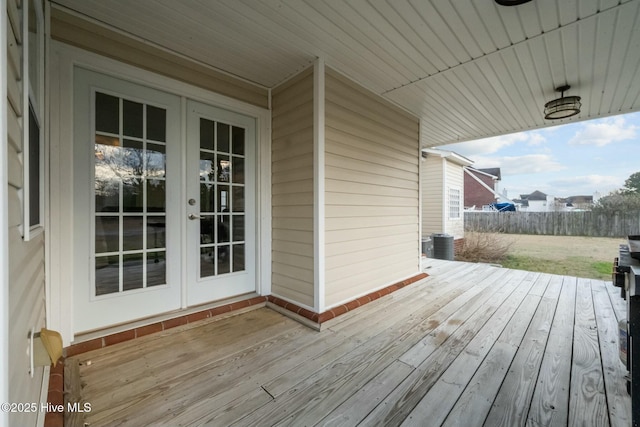 wooden terrace featuring central air condition unit and french doors