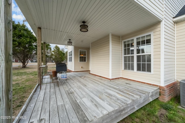 deck with grilling area and a yard