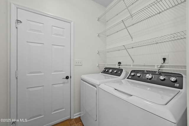 laundry area featuring washing machine and clothes dryer and laundry area