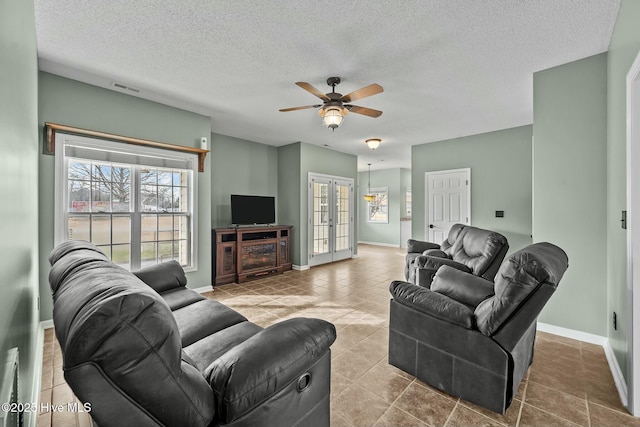 living room featuring french doors, a textured ceiling, tile patterned floors, ceiling fan, and visible vents