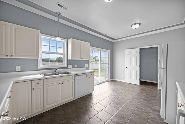 kitchen with crown molding, a sink, white appliances, and light countertops