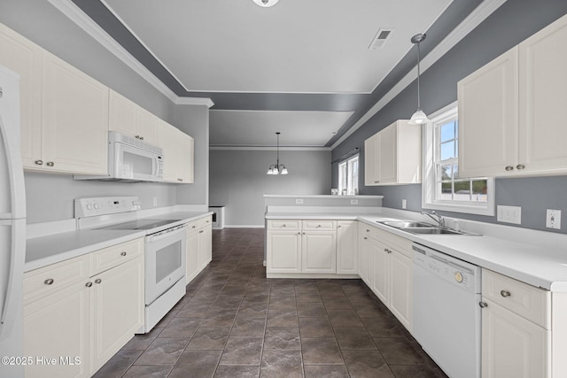 kitchen featuring visible vents, crown molding, a sink, white appliances, and white cabinetry
