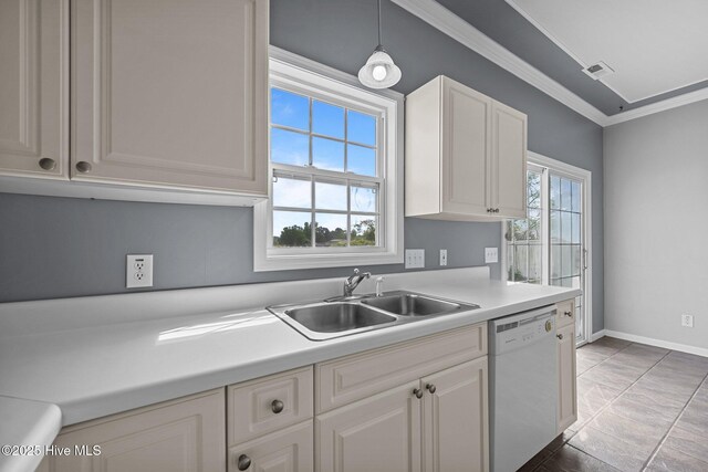 kitchen with white dishwasher, crown molding, light countertops, a sink, and white cabinets