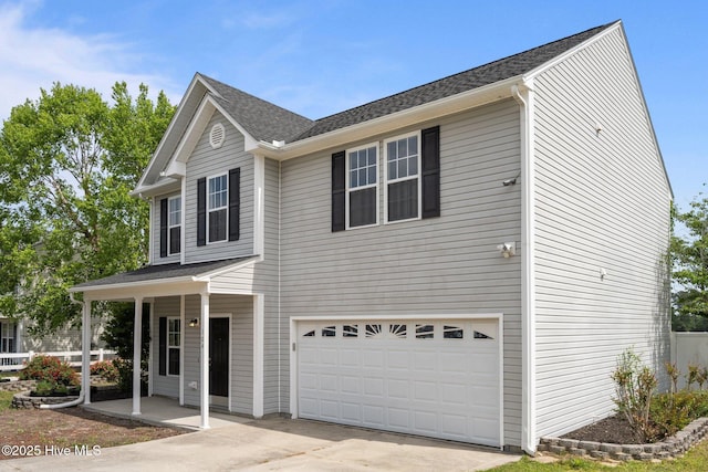 view of front of house with a porch, concrete driveway, and a garage