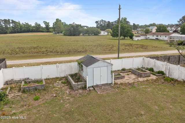 exterior space with a storage unit, an outdoor structure, a fenced backyard, and a vegetable garden