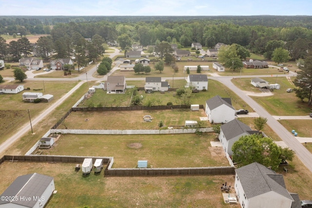 drone / aerial view featuring a forest view and a residential view