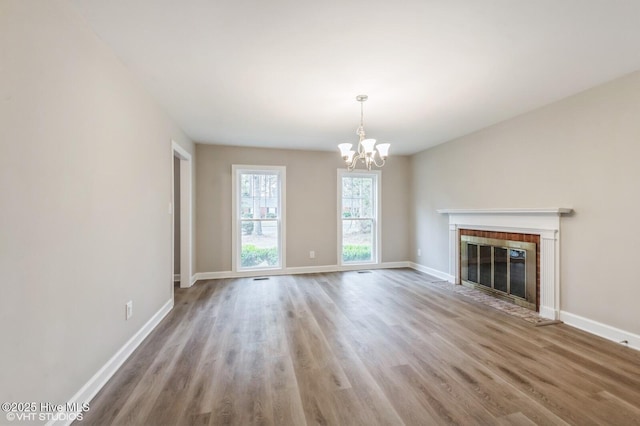 208 Elm St, Whiteville, NC 28472 - unfurnished living room with an inviting chandelier, baseboards, and wood finished floors