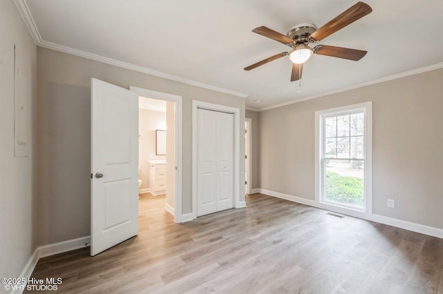 208 Elm St, Whiteville, NC 28472 - unfurnished bedroom featuring ornamental molding, light wood finished floors, and visible vents