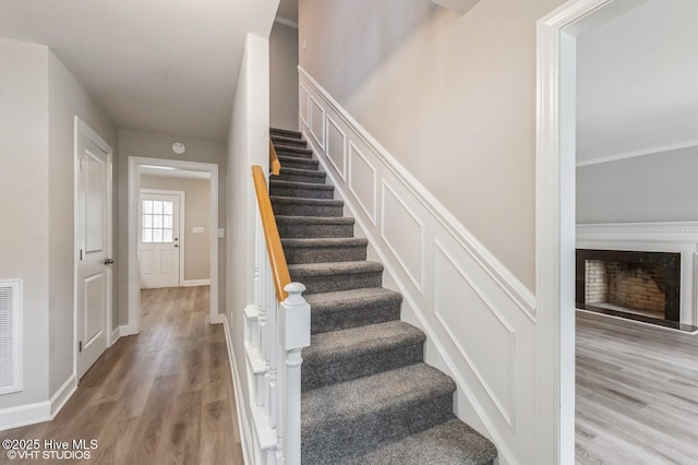 208 Elm St, Whiteville, NC 28472 - stairs with baseboards, a fireplace, and wood finished floors