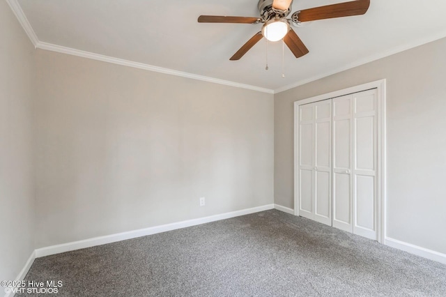 208 Elm St, Whiteville, NC 28472 - unfurnished bedroom with a closet, ornamental molding, baseboards, and dark colored carpet