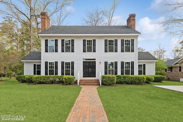 208 Elm St, Whiteville, NC 28472 - colonial inspired home with a front yard, a shingled roof, and a chimney