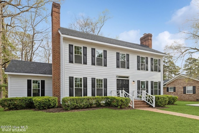208 Elm St, Whiteville, NC 28472 - colonial-style house with a front yard and a chimney