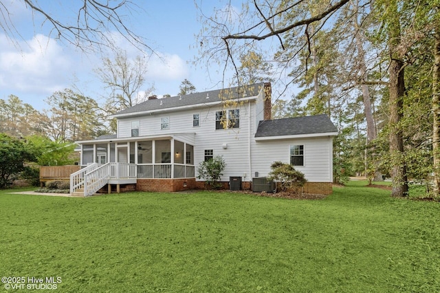 208 Elm St, Whiteville, NC 28472 - rear view of property with central AC unit, a lawn, a chimney, and a sunroom
