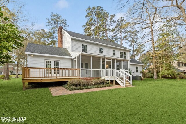 208 Elm St, Whiteville, NC 28472 - back of property with a chimney, a shingled roof, a sunroom, and a yard