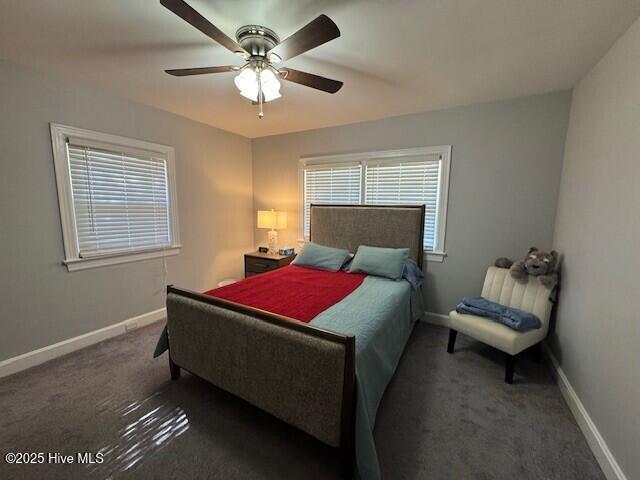 bedroom featuring baseboards, a ceiling fan, and carpet