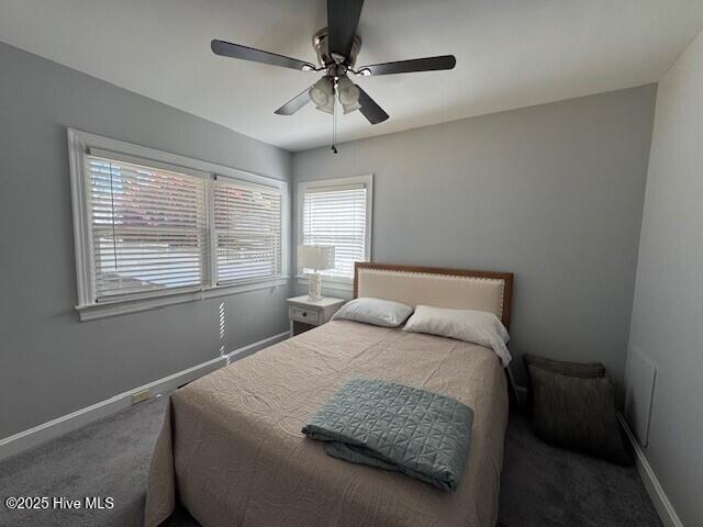 bedroom with baseboards, carpet flooring, and a ceiling fan