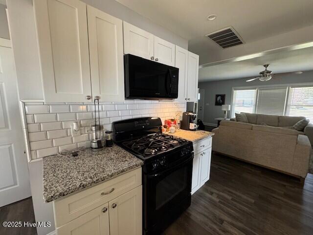 kitchen with visible vents, black appliances, dark wood-style flooring, and white cabinets