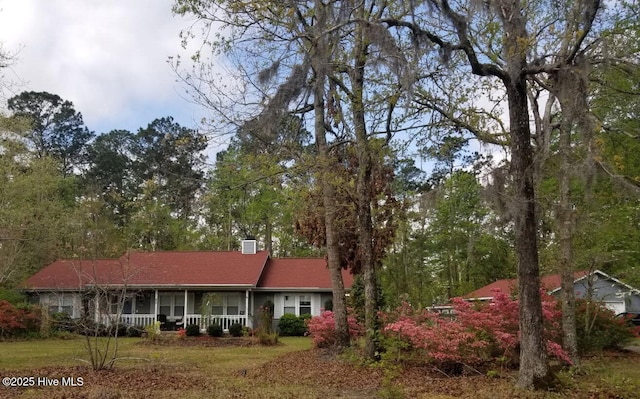 ranch-style house with covered porch and a chimney