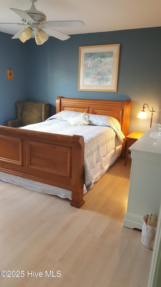 bedroom with light wood-type flooring and ceiling fan