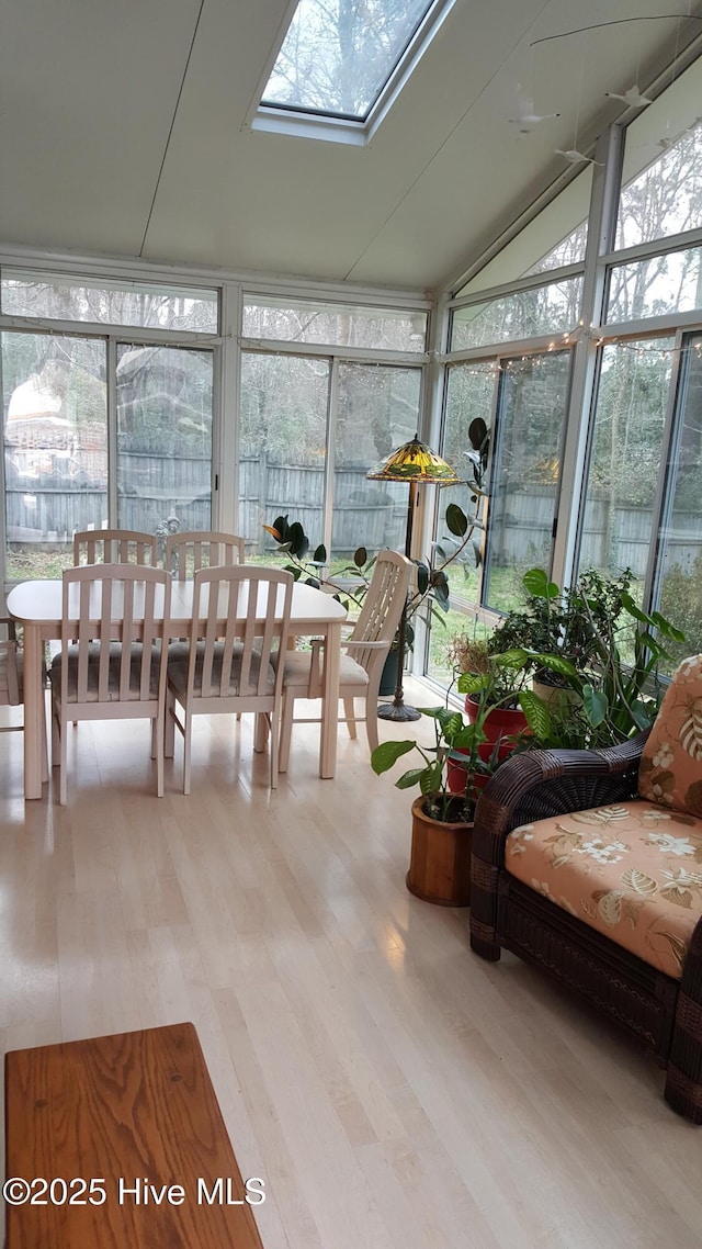sunroom with floor to ceiling windows, wood finished floors, and a wealth of natural light
