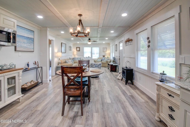 dining area featuring recessed lighting, a healthy amount of sunlight, a wainscoted wall, and light wood-style flooring
