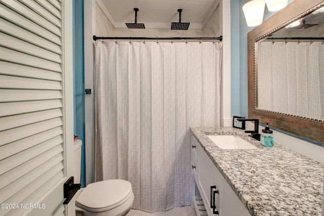 bathroom featuring toilet, vanity, and a shower with shower curtain