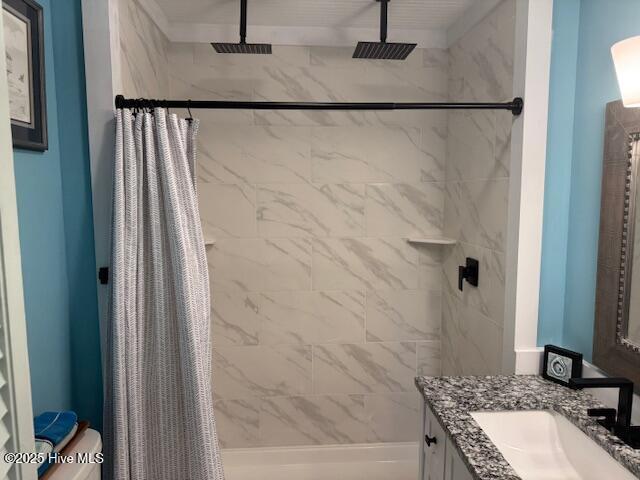 full bathroom featuring a shower stall and vanity
