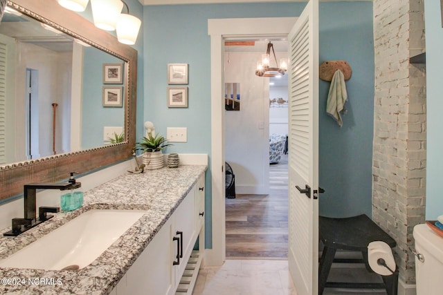 ensuite bathroom featuring toilet, vanity, and ensuite bathroom