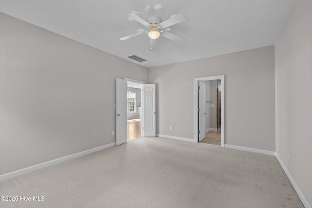512 Village Green Dr Unit A, Morehead City, NC 28557 - unfurnished bedroom with light carpet, baseboards, connected bathroom, and ceiling fan