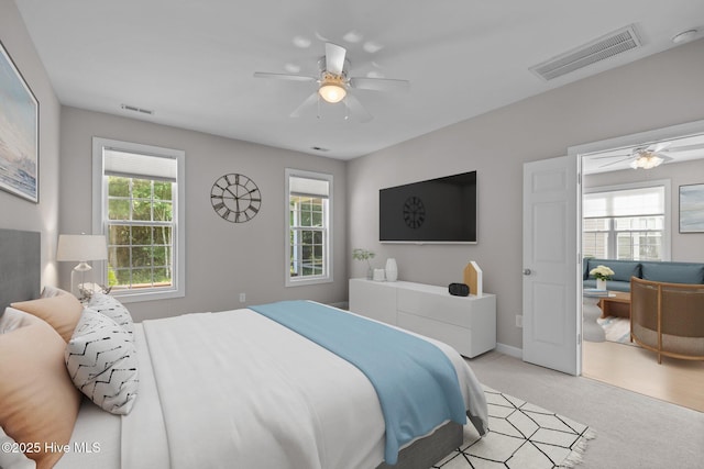 512 Village Green Dr Unit A, Morehead City, NC 28557 - bedroom featuring light carpet, ceiling fan, and baseboards