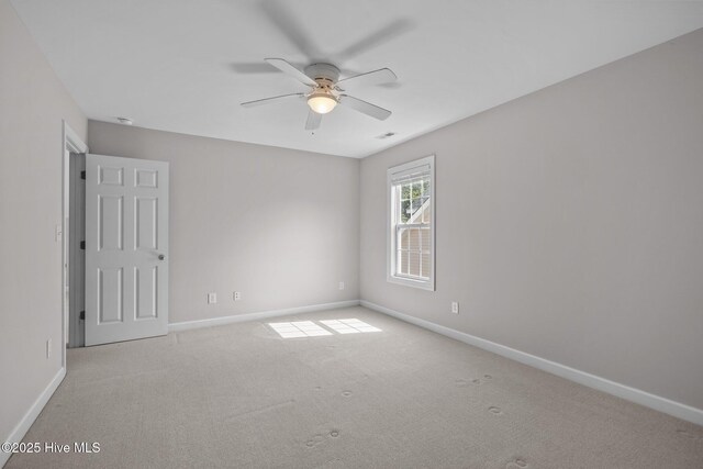 512 Village Green Dr Unit A, Morehead City, NC 28557 - unfurnished room featuring a ceiling fan, baseboards, and carpet flooring