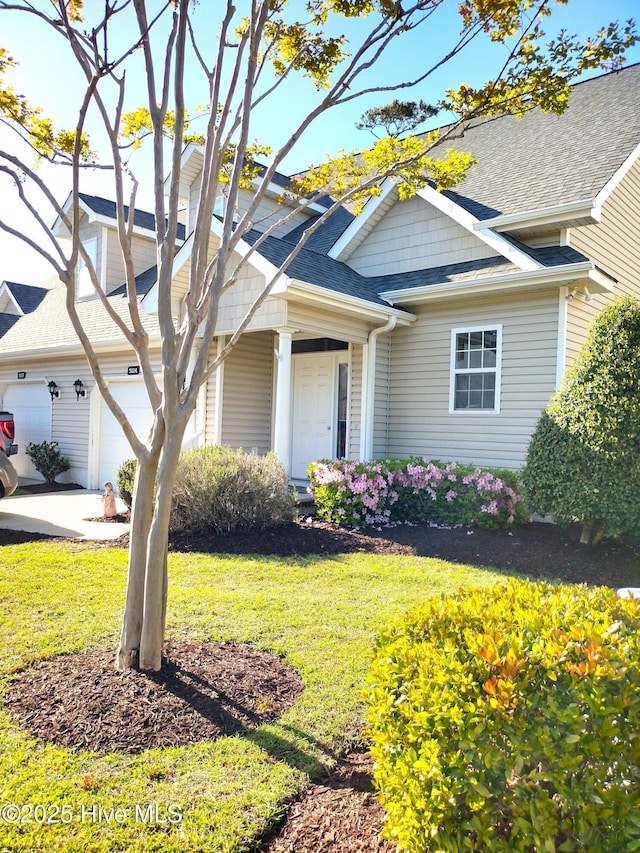 512 Village Green Dr Unit A, Morehead City, NC 28557 - view of front of house with a shingled roof, a front yard, and a garage