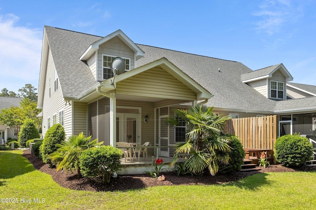 512 Village Green Dr Unit A, Morehead City, NC 28557 - view of front of property featuring a front yard, roof with shingles, and a sunroom