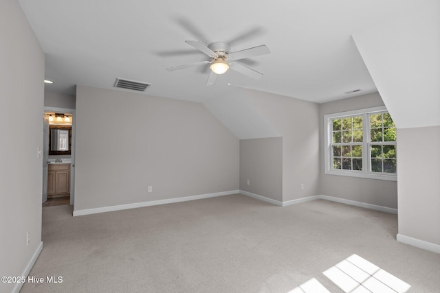 512 Village Green Dr Unit A, Morehead City, NC 28557 - additional living space with light carpet, a ceiling fan, baseboards, and vaulted ceiling