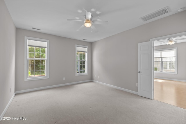 512 Village Green Dr Unit A, Morehead City, NC 28557 - carpeted empty room featuring ceiling fan, plenty of natural light, and baseboards