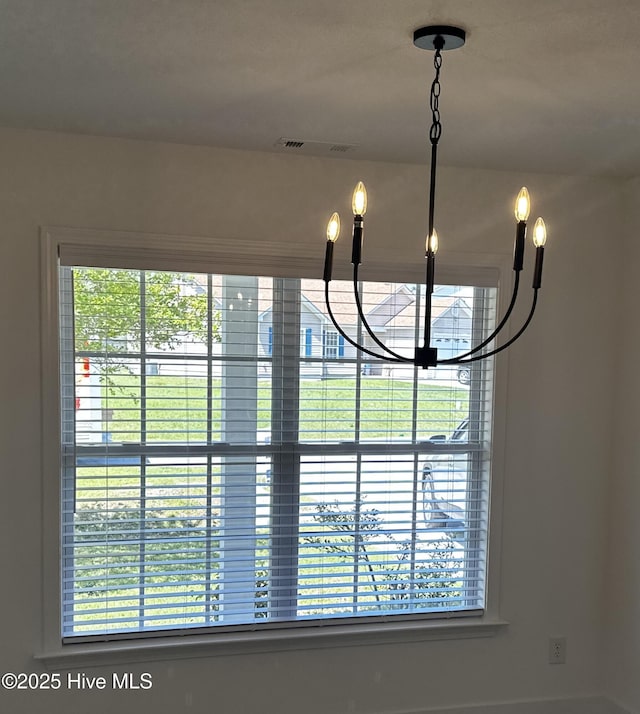 details featuring a notable chandelier and visible vents