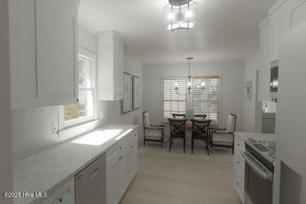 kitchen with a chandelier, light wood-style flooring, white cabinets, appliances with stainless steel finishes, and hanging light fixtures